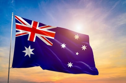australia-flag-national-hand-hold-blue-sky-beach-with-sunlight_430468-412